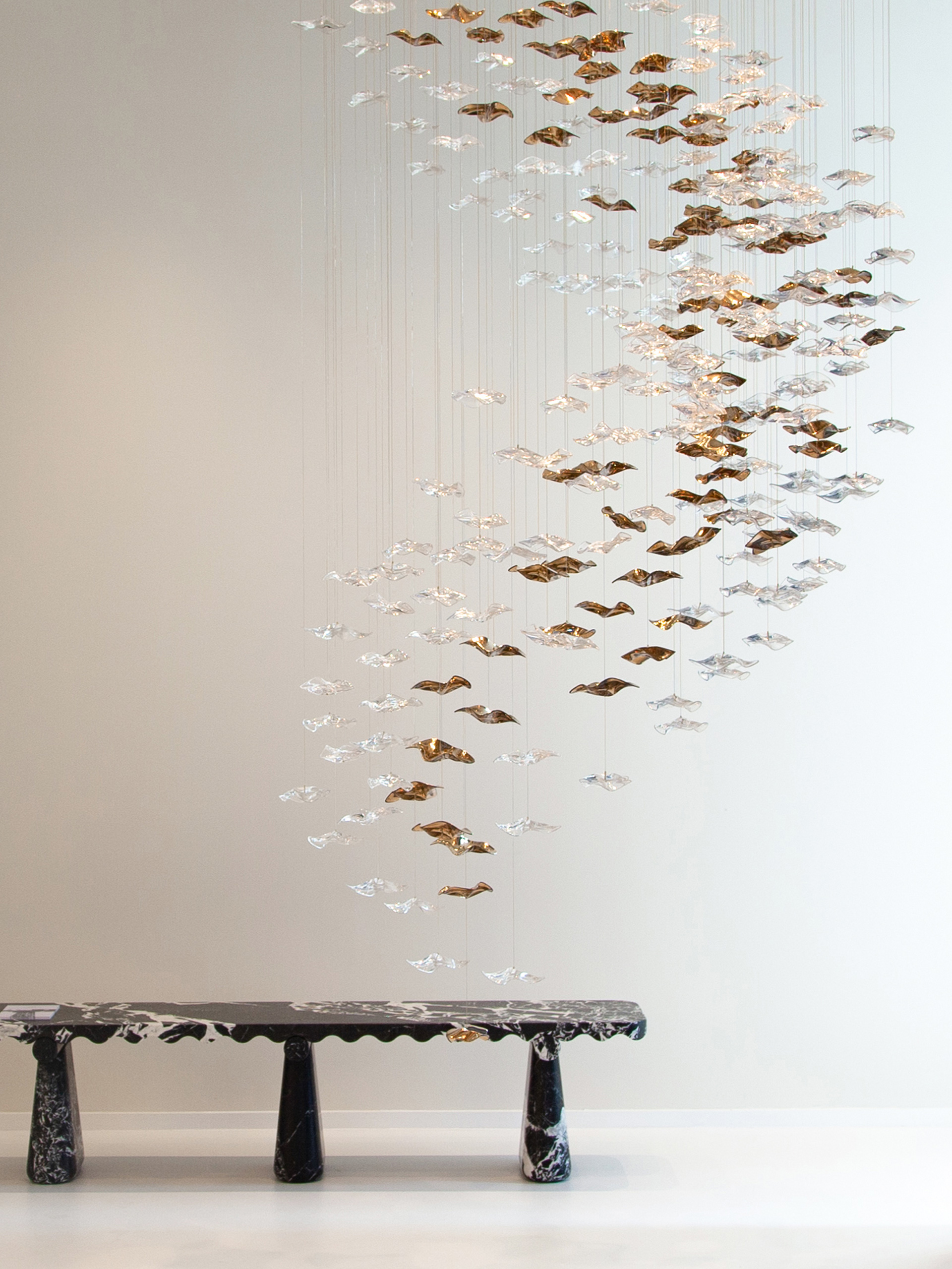 Sand & Sea lighting composition suspended above a marble bench in the Haberdashery showroom