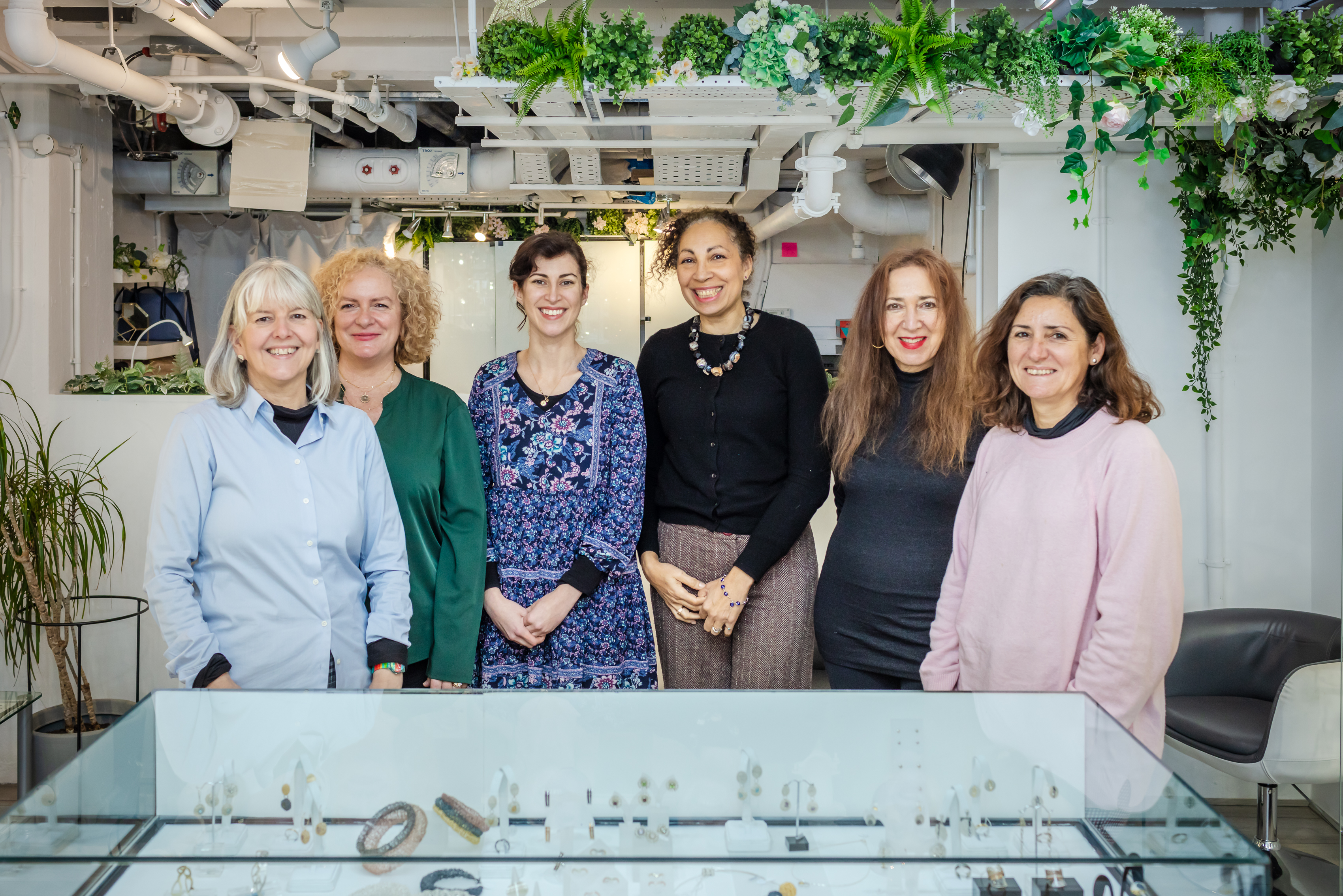 Six jewellers from the Jedeco jewellery collective stand in their showroom at Oxo Tower Wharf