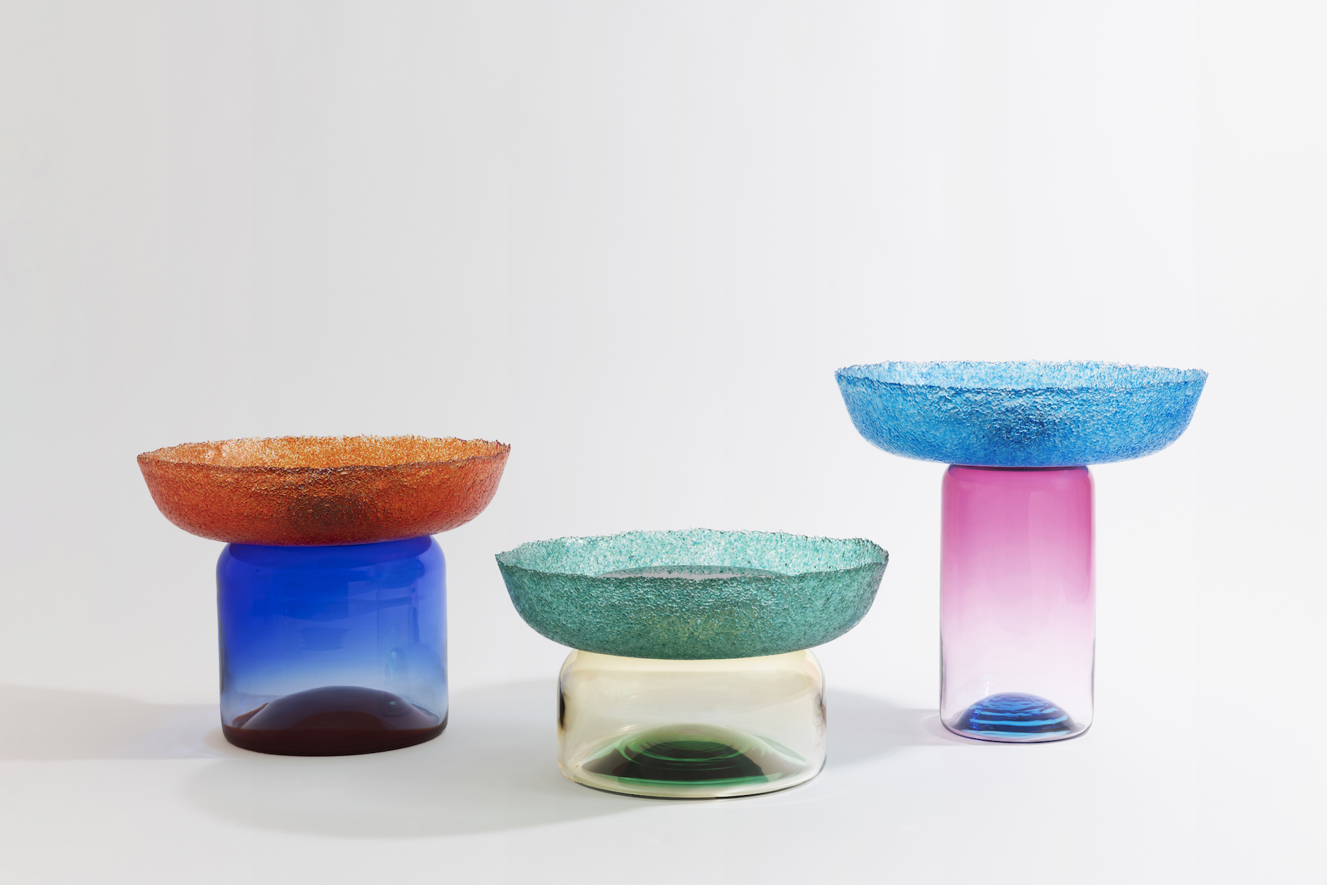 Three colourful glass objects