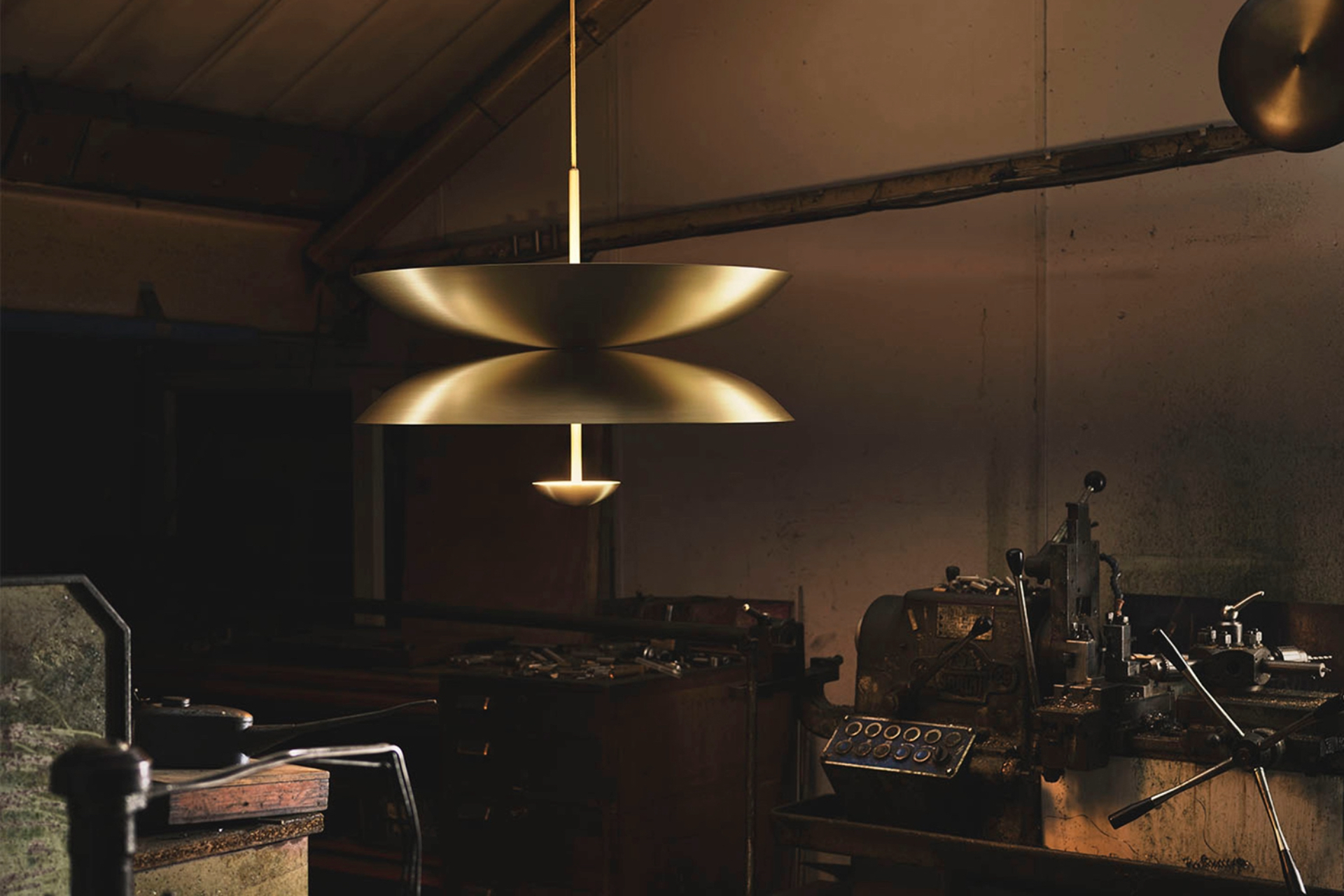 Duo Pendant hanging in the brass workshop