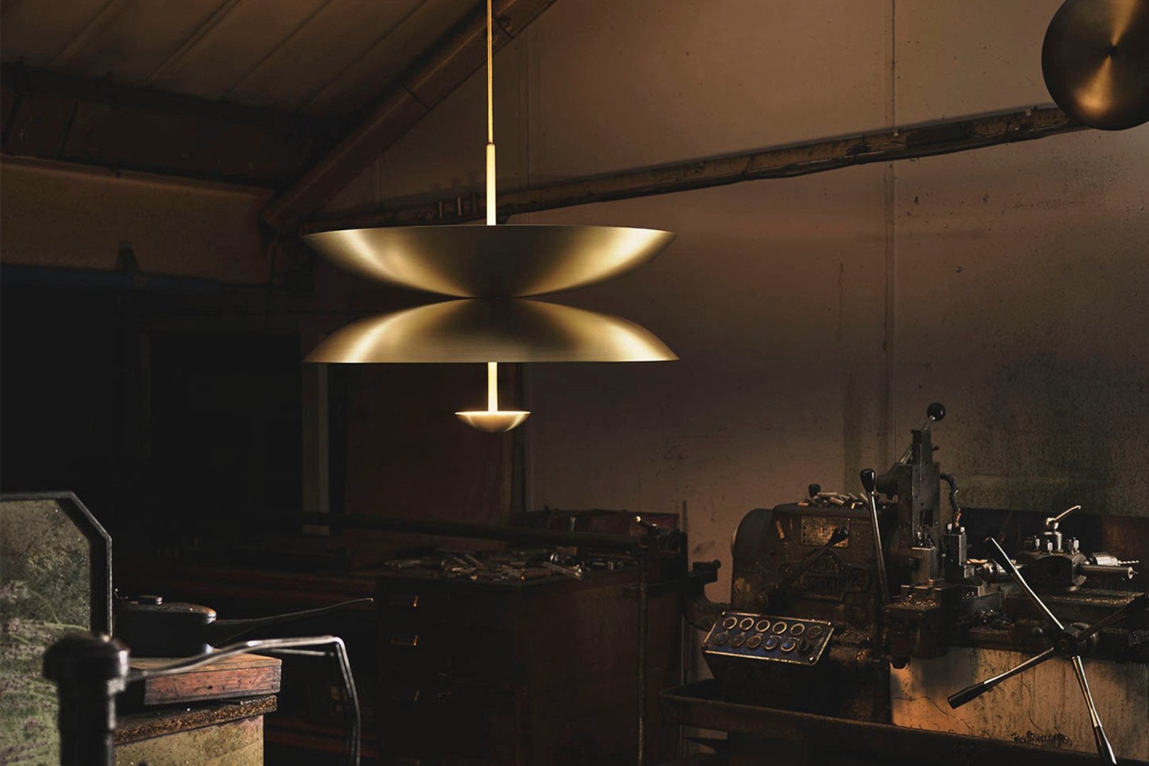 Duo Pendant hanging in the brass workshop