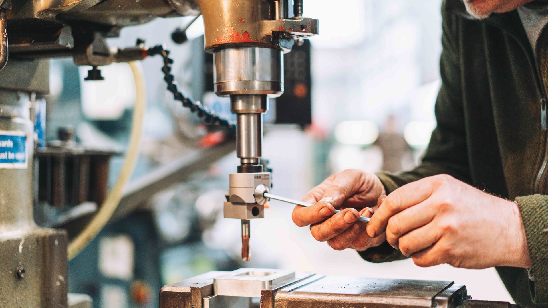 Man uses drill at BLOQS London Metal Works