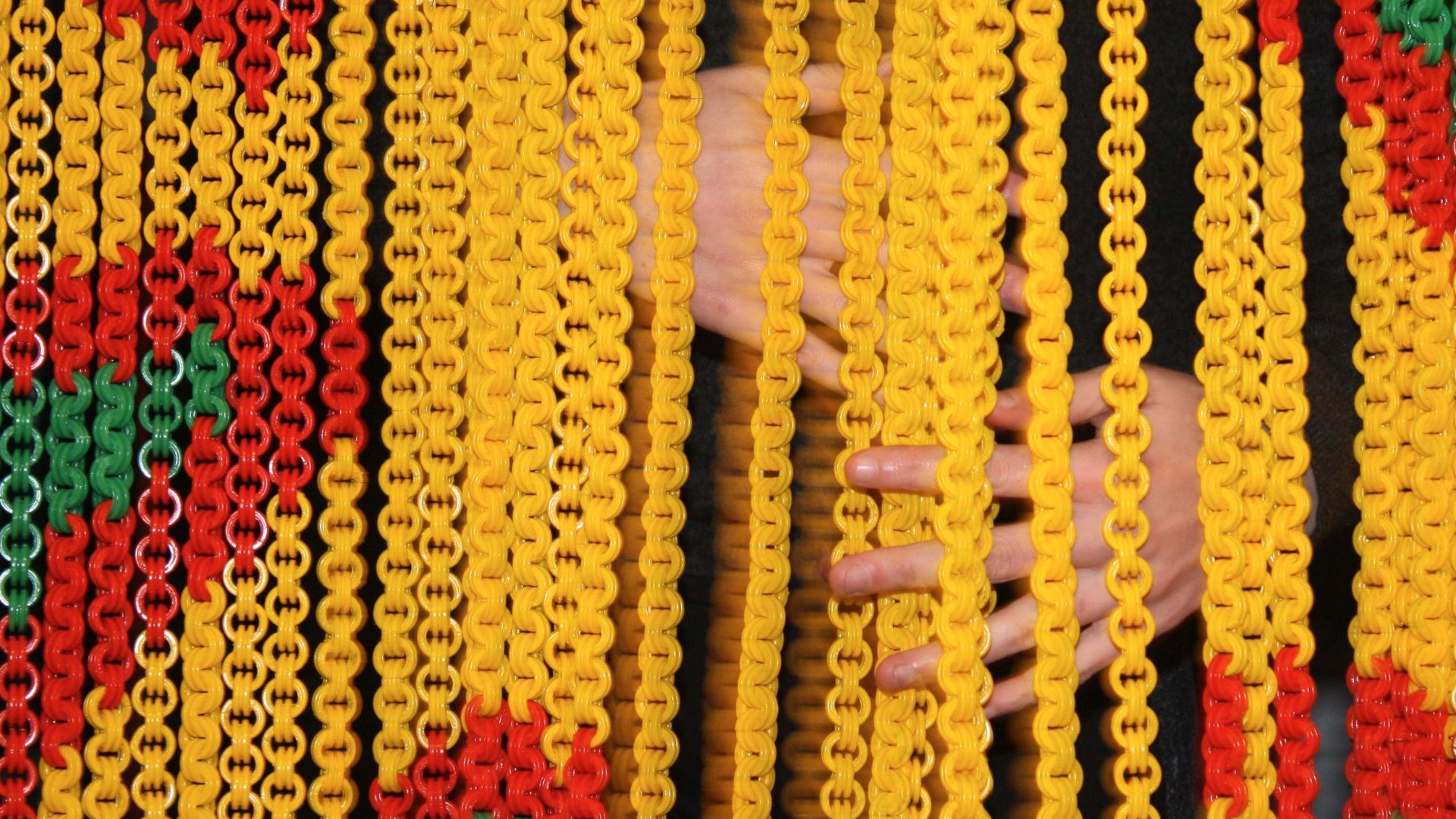 Detail of curtain object in red, yellow, green by Emma Cogné