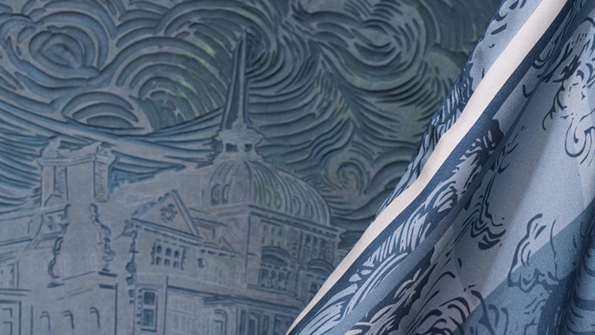 Textured linocut block with clouds and swirls, beside a blue silk scarf inspired by the coast