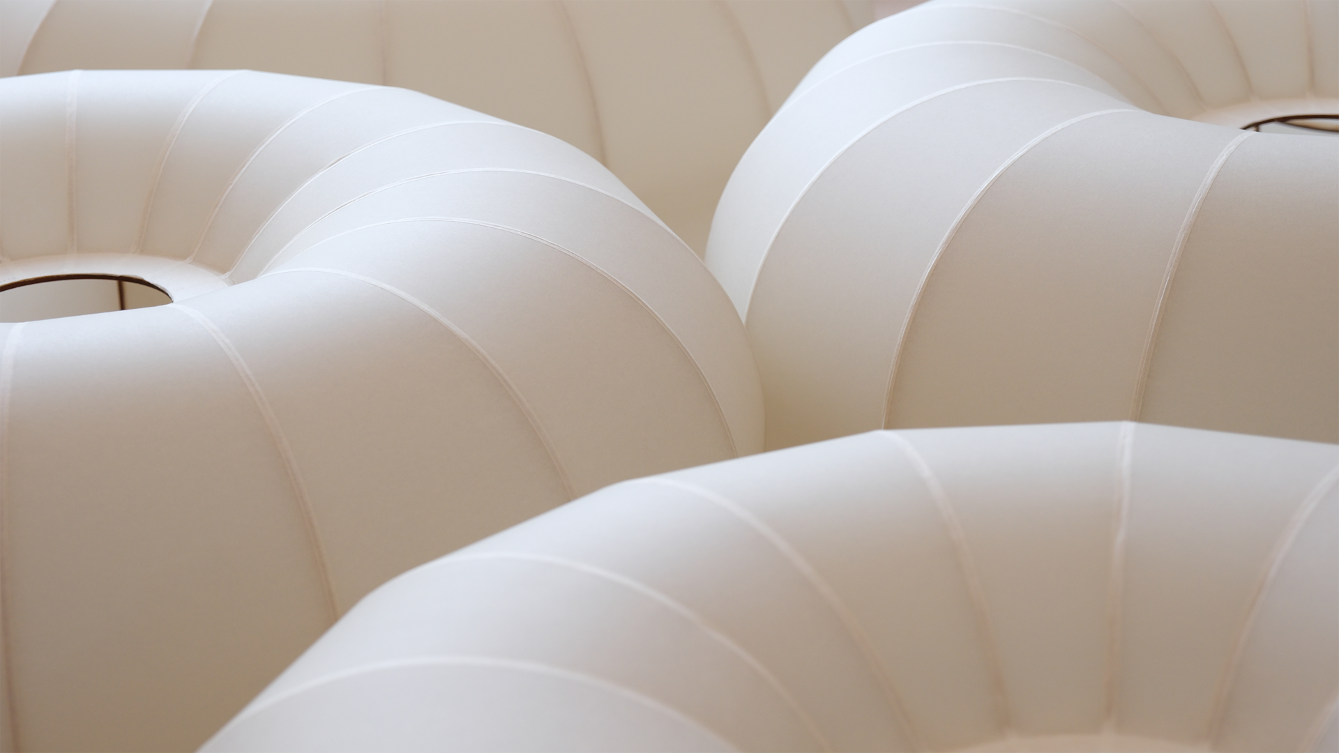 A group of torus shaped lampshades made from paper 