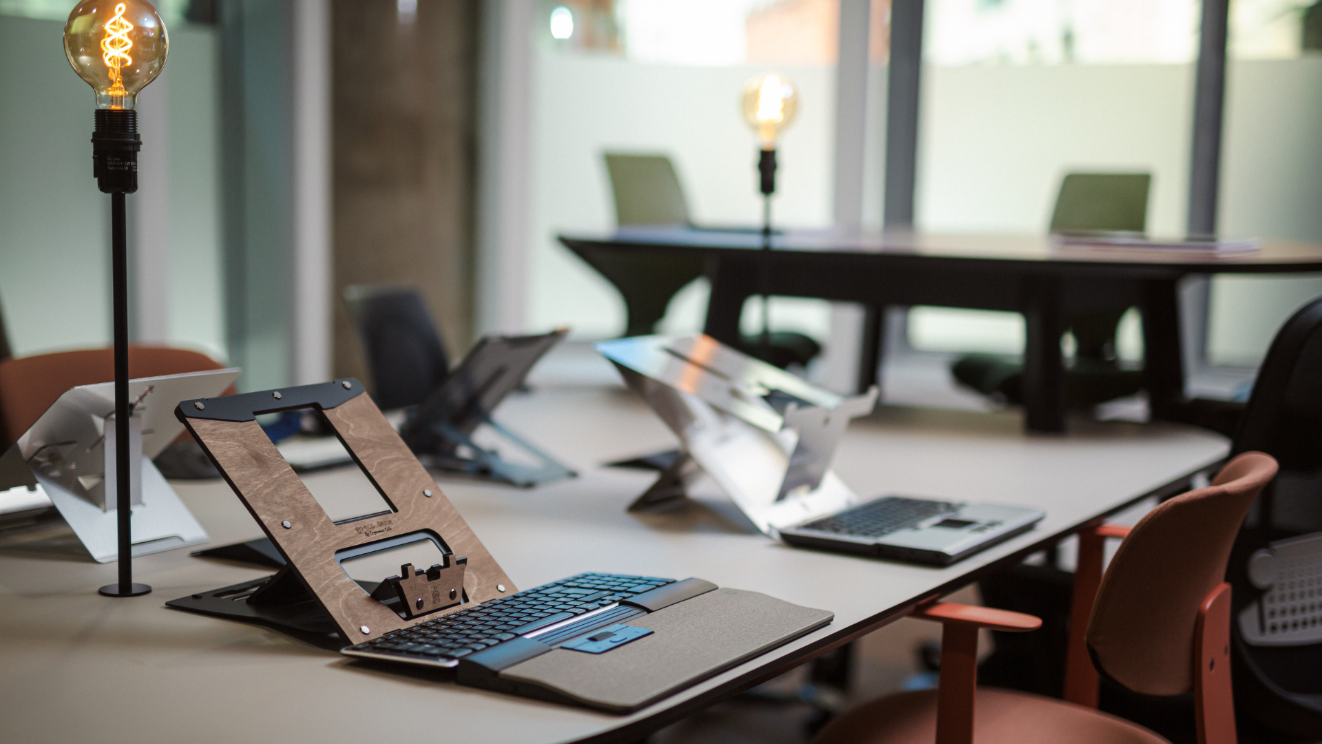 Remtek products including ergonomic laptop stands, keyboards and workplace accessories displayed in a modern office workspace