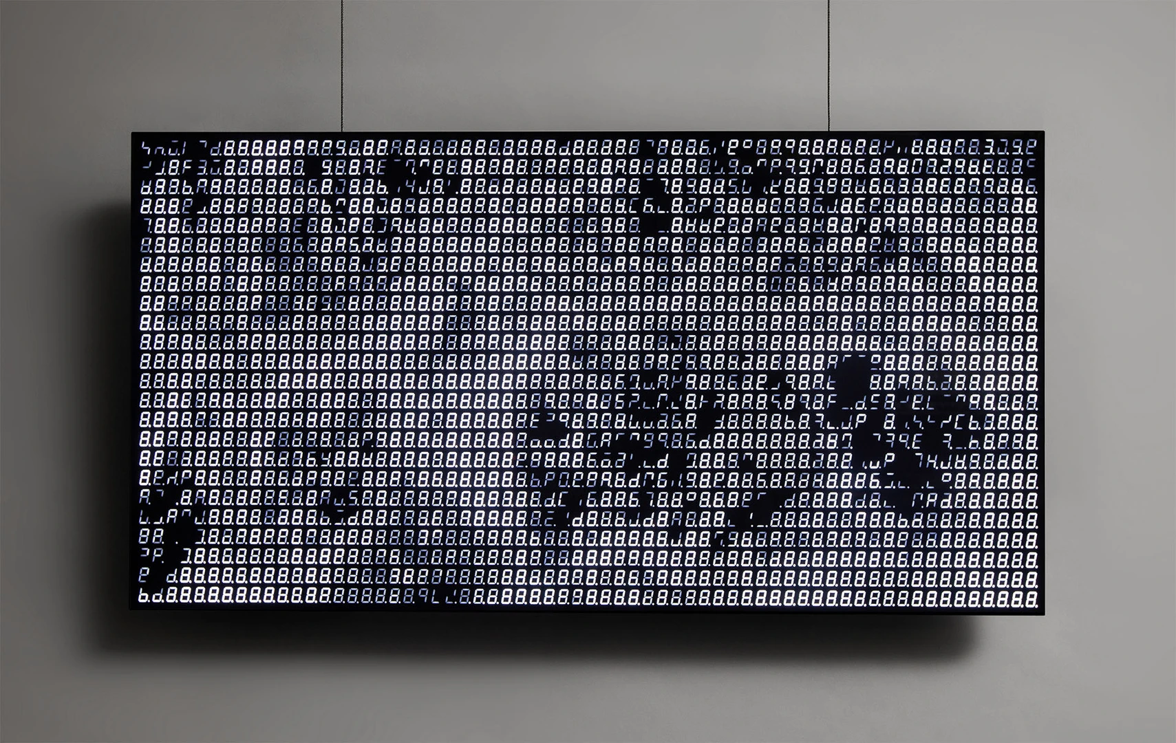 Effervescent, frothing waves wash over a screen formed of seven-segment displays