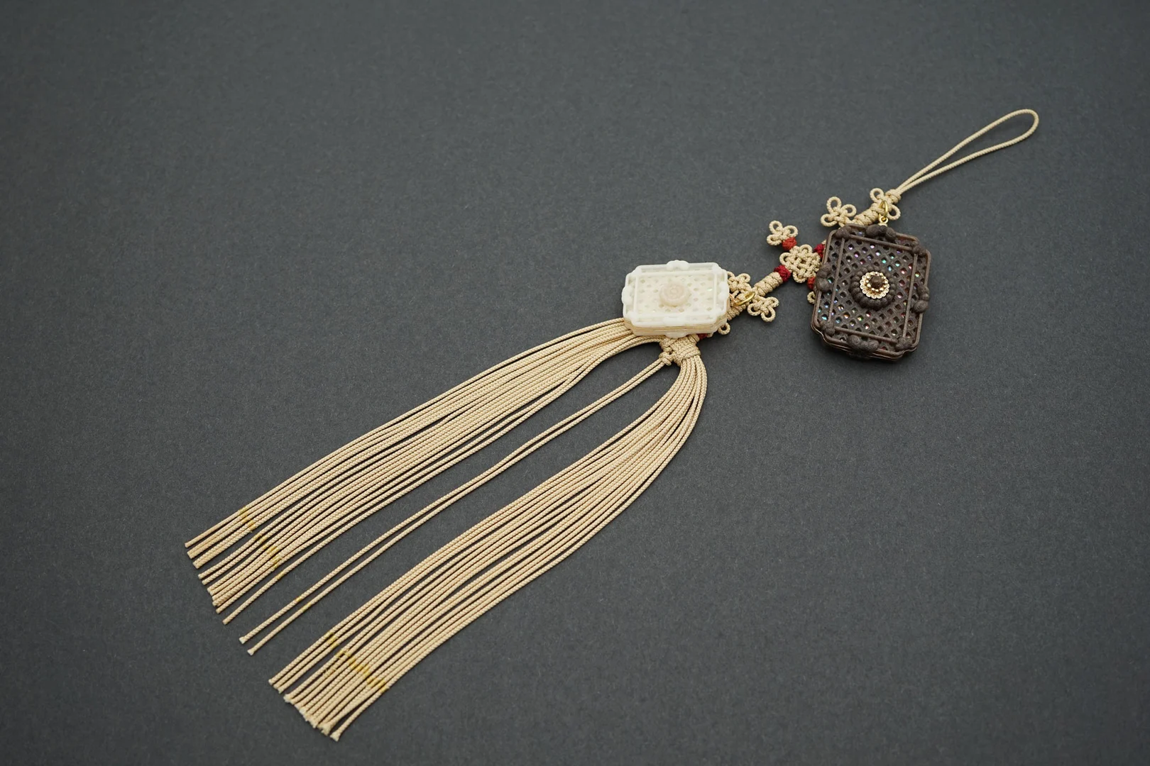 The Square charm Norigae, a waist of charm, made of recycled coffee grounds and Korean tradition knot.