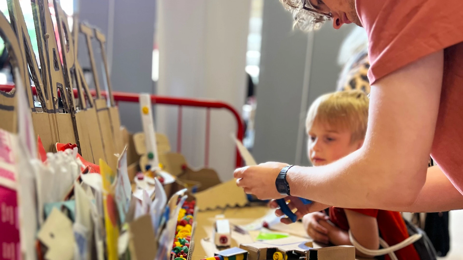 Small Boy interested in snapkit being helped to build something