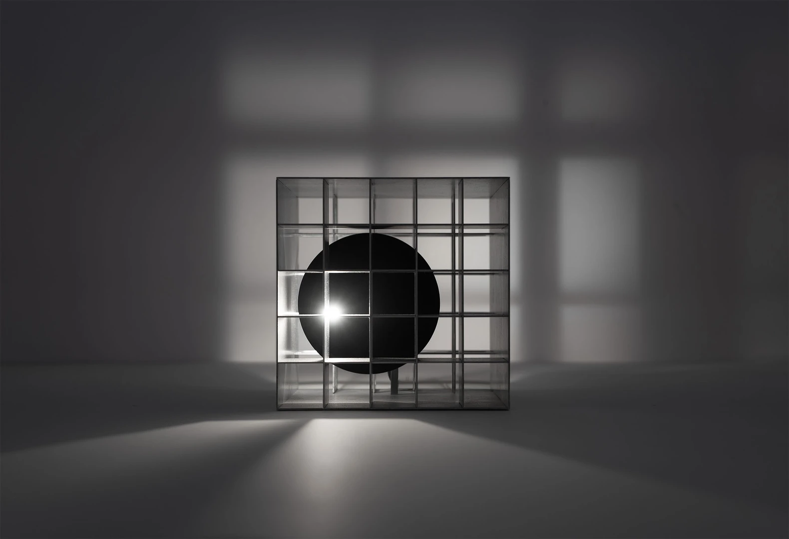 A light source moves through a grid structure, creating extraordinary shadows. 