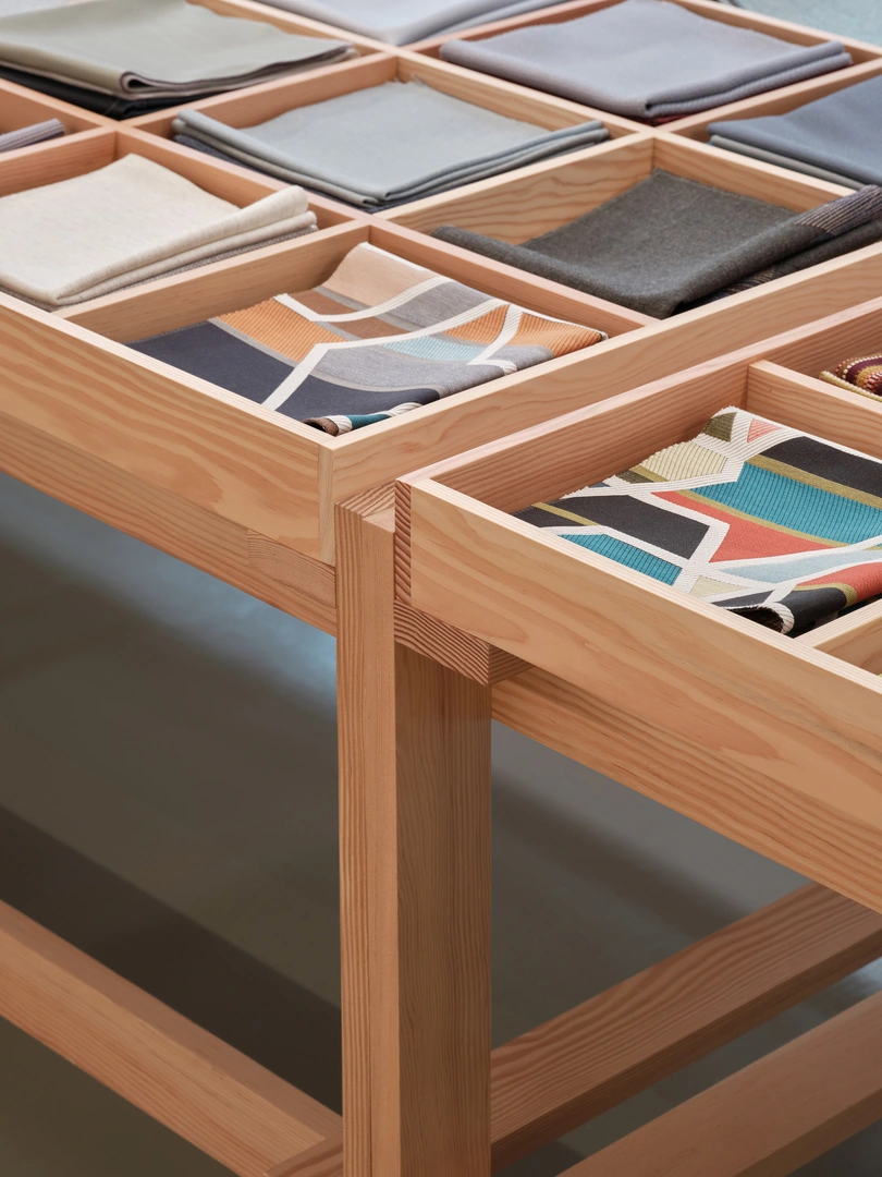 Maharam showroom detailed view of wooden display table.