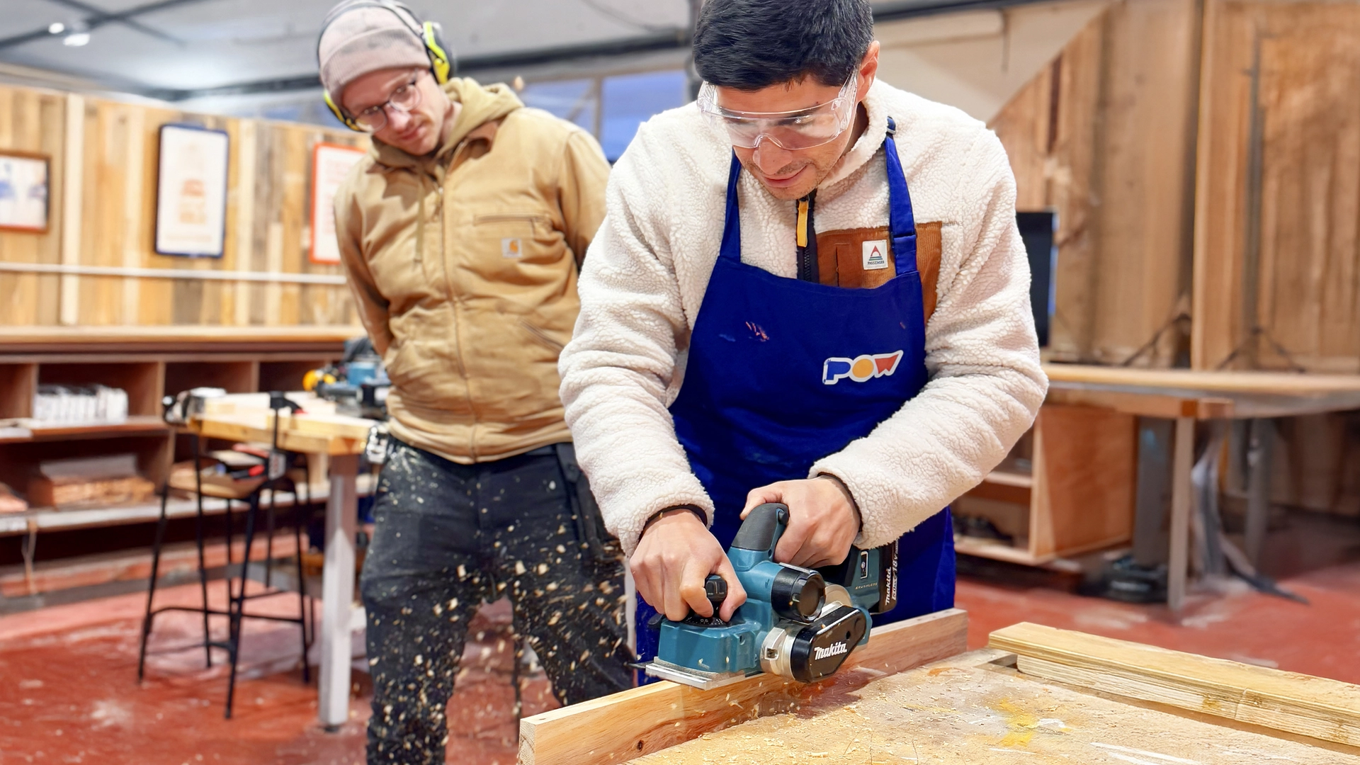 Student and teacher at a power tools workshop.
