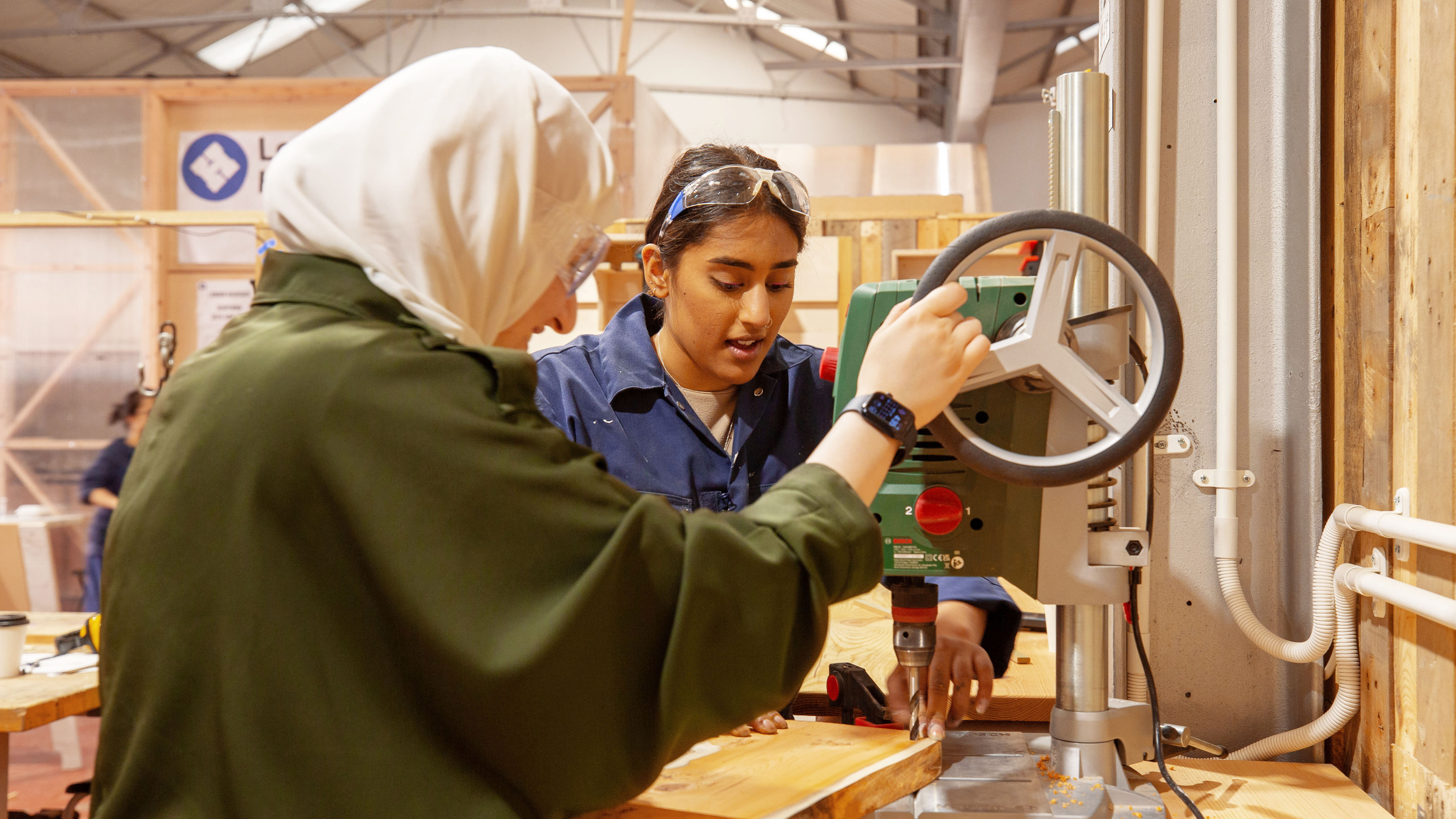Student and teacher at a serving board making workshop.