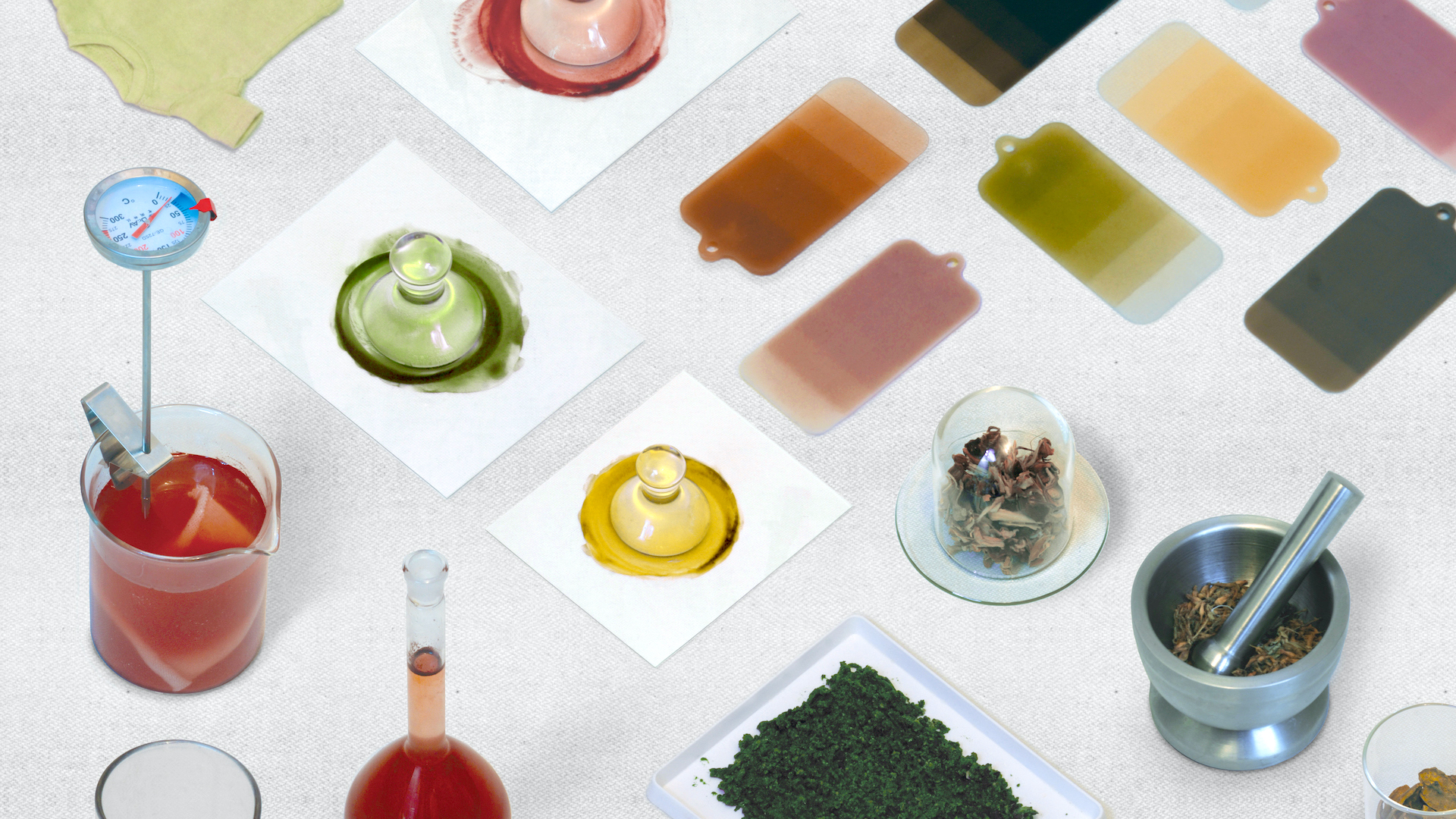 Samples of natural dyes and colouration in different vessels and on colour cards