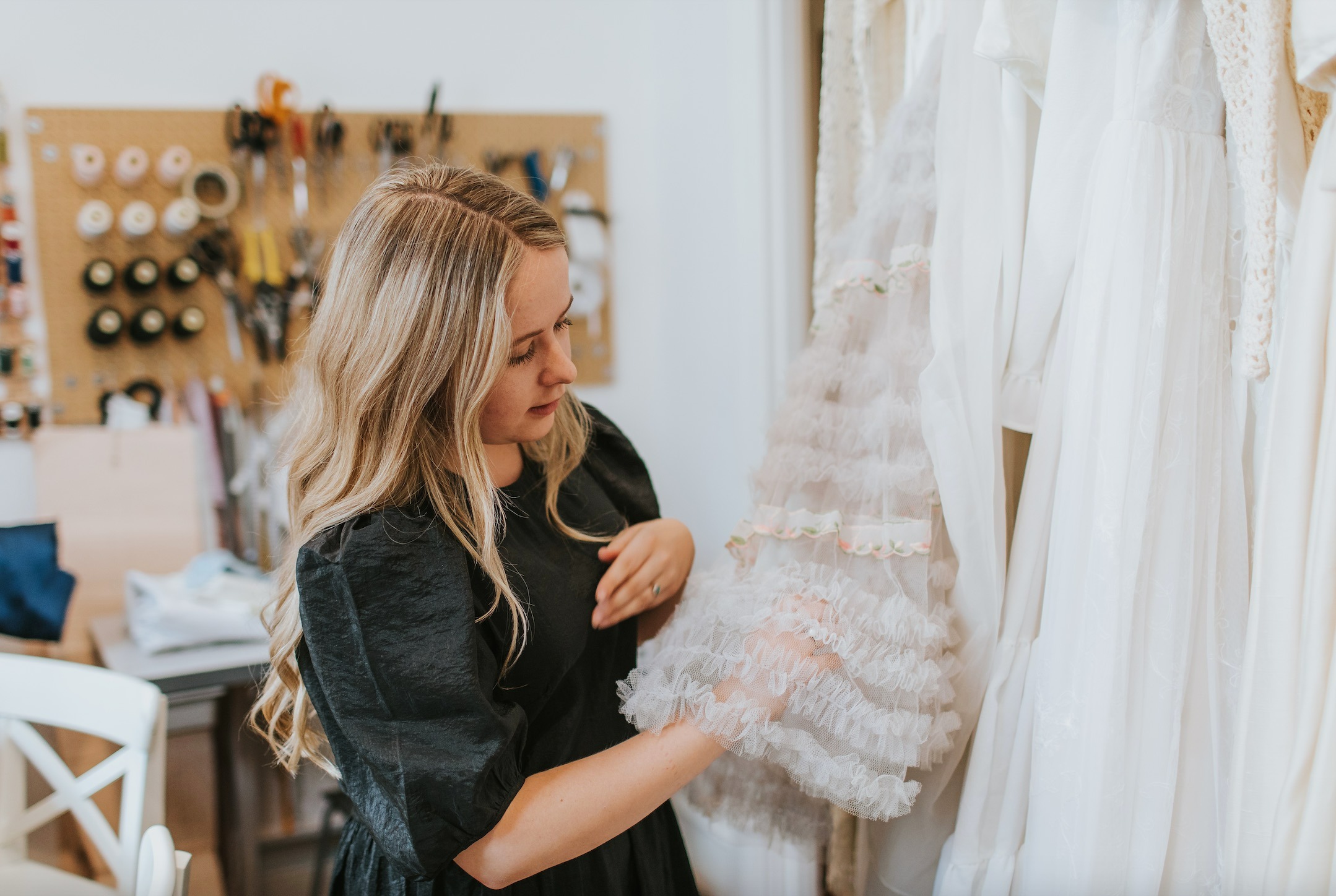 Image of a woman looking at a wedding dress.