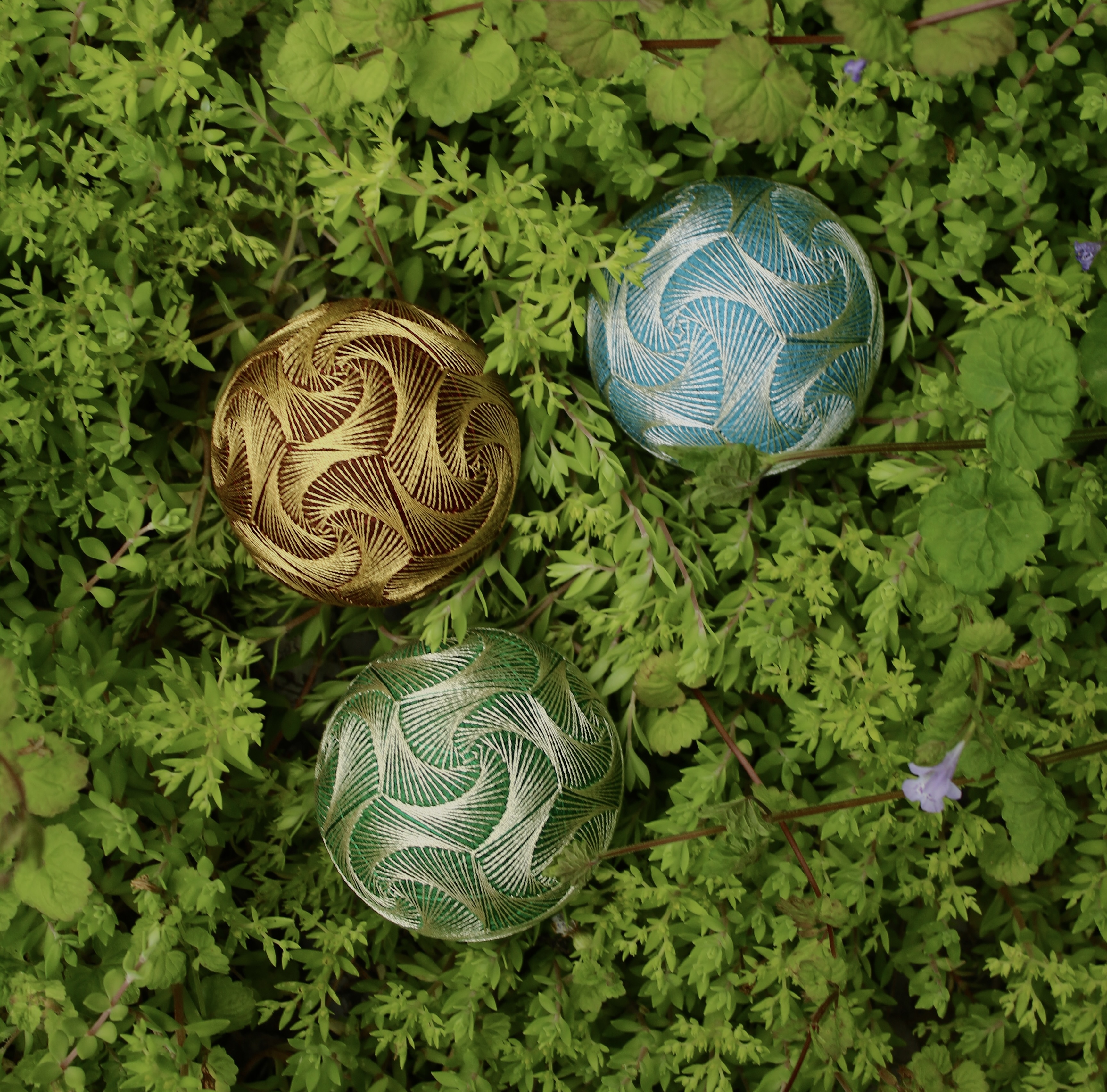 A core of Rice husks is wrapped about with coloured threads. Each stitch imbued with a wish for a healthy earth now.