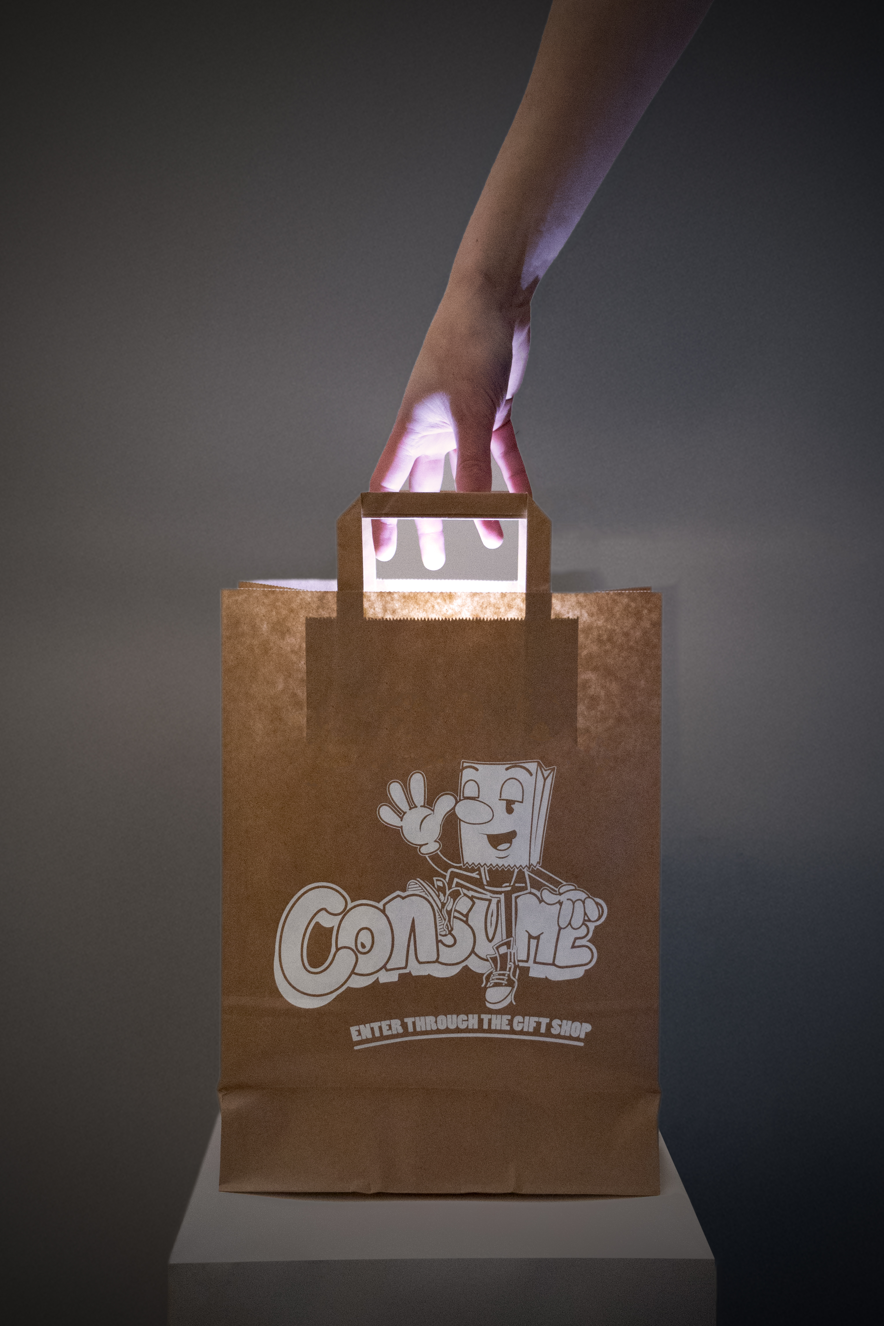 a glowing brown paper bag with a hand reaching in from above