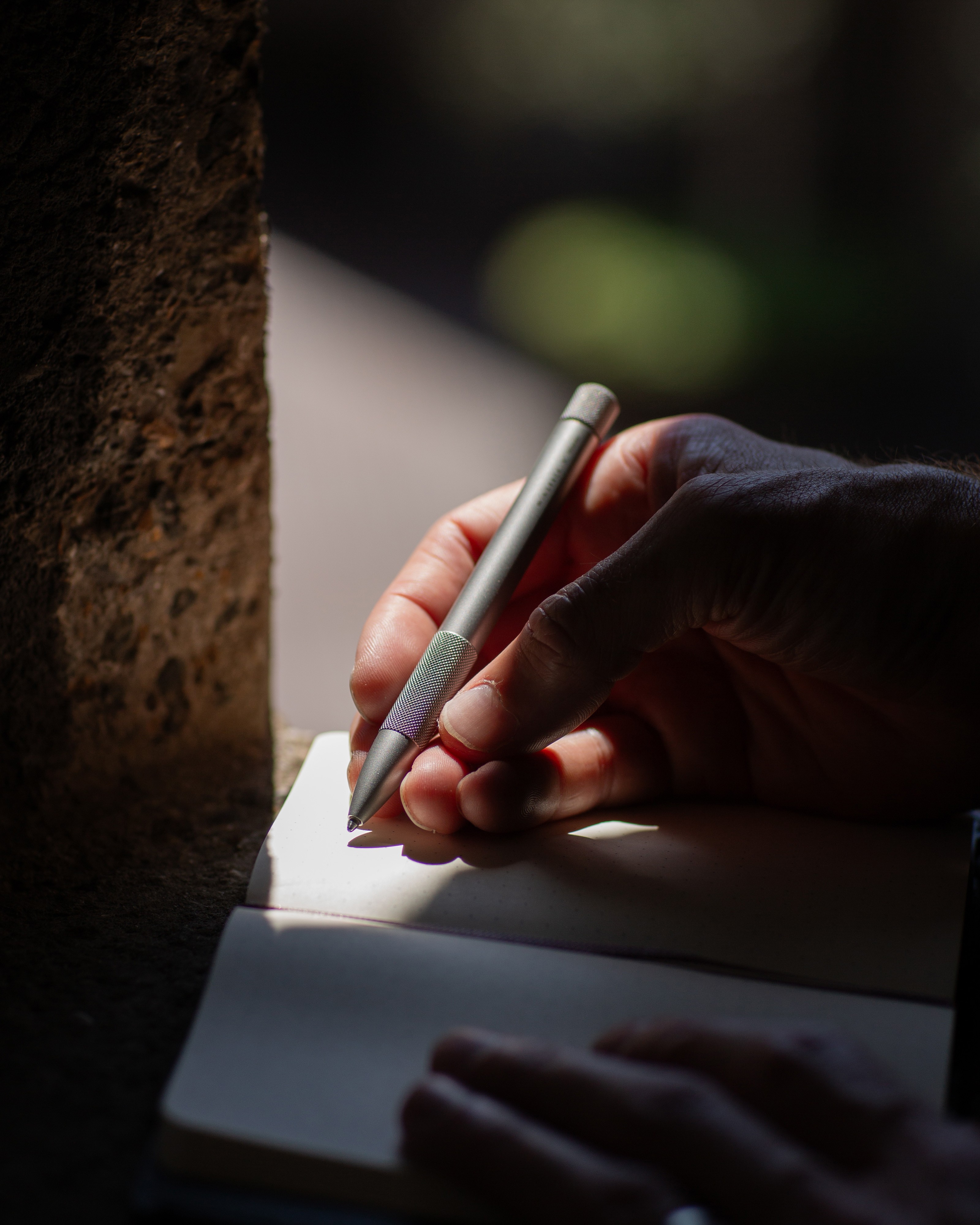Image of someone writing with a pen.