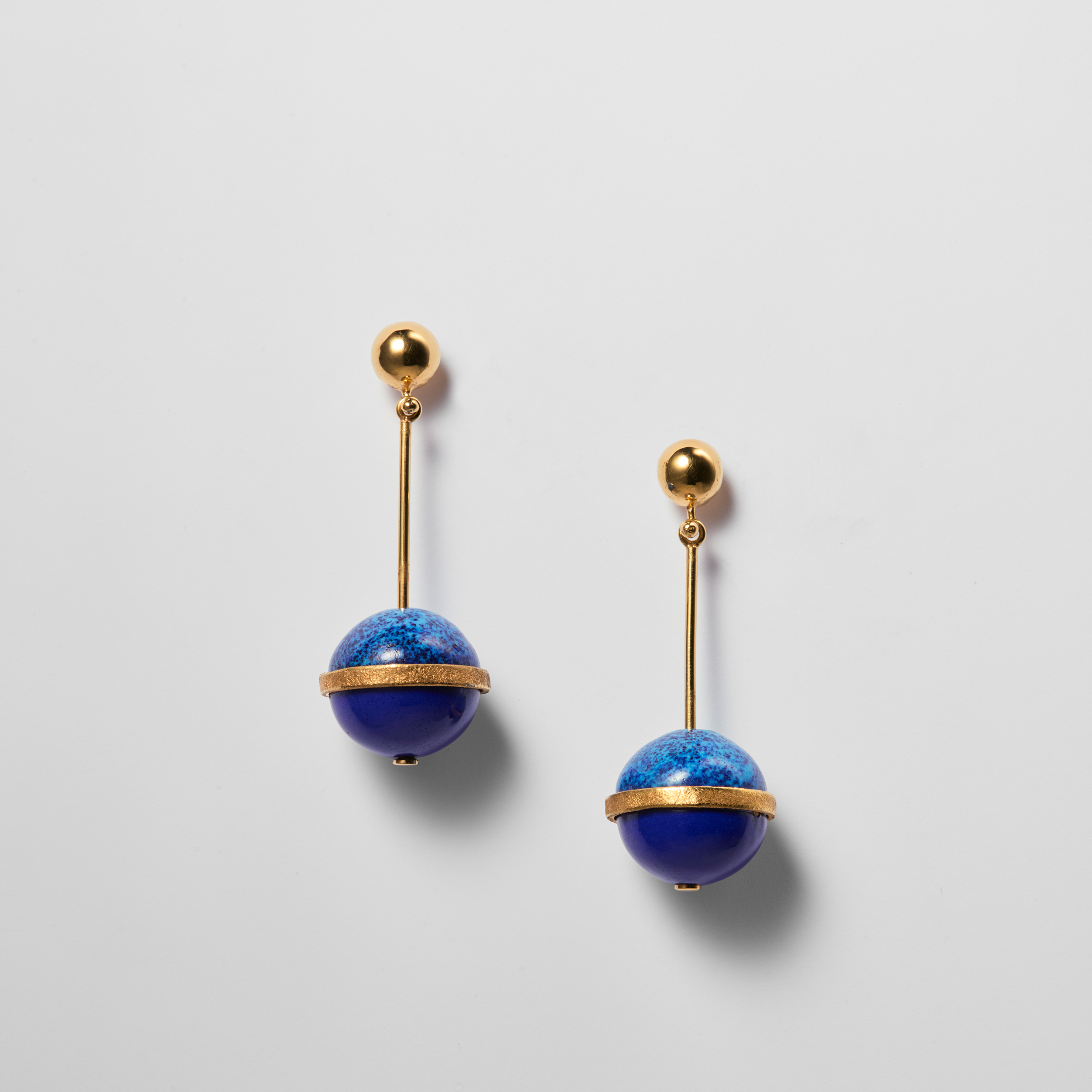 Image of a pair of blue round earrings.