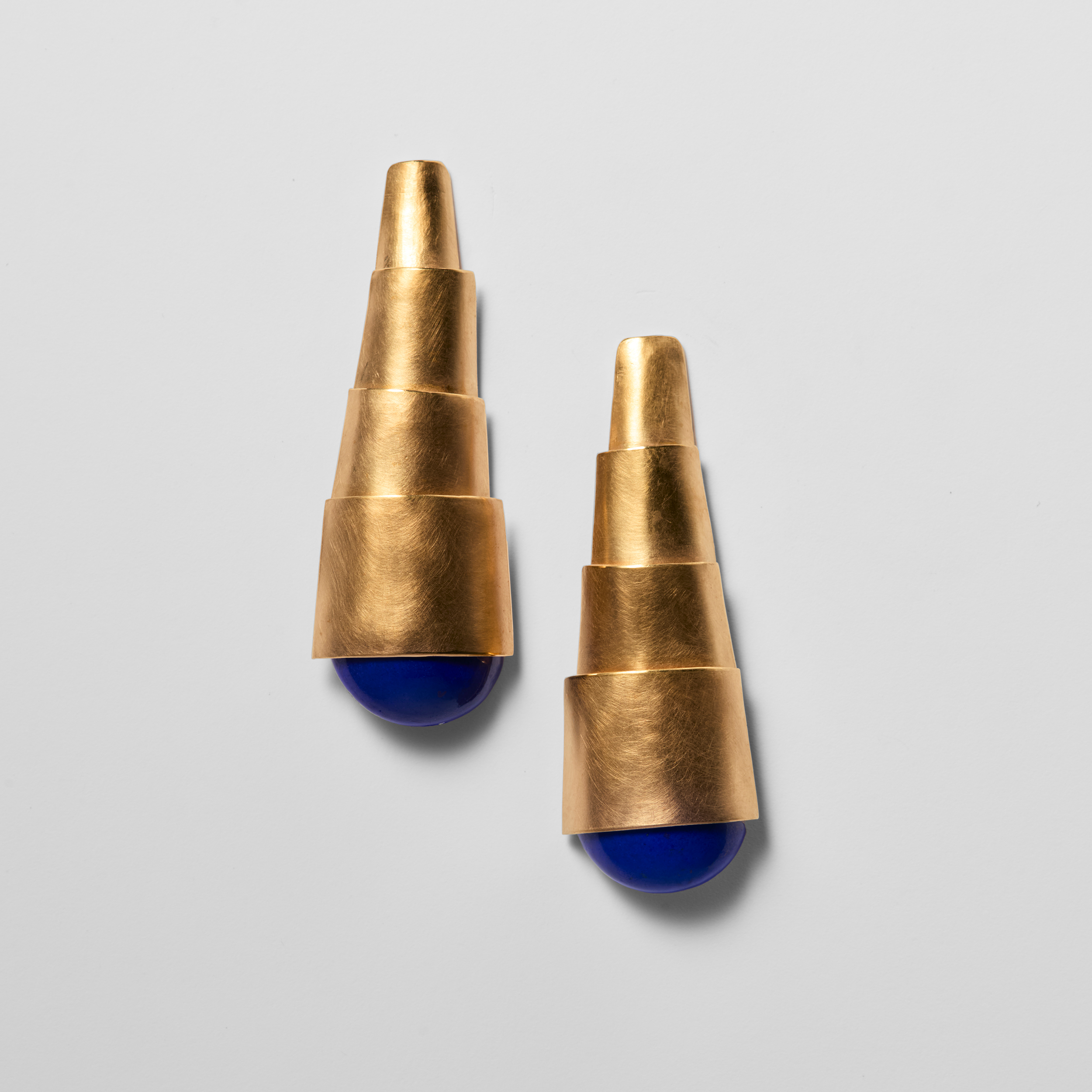 Image of a pair of two earrings shaped like a looking glass.