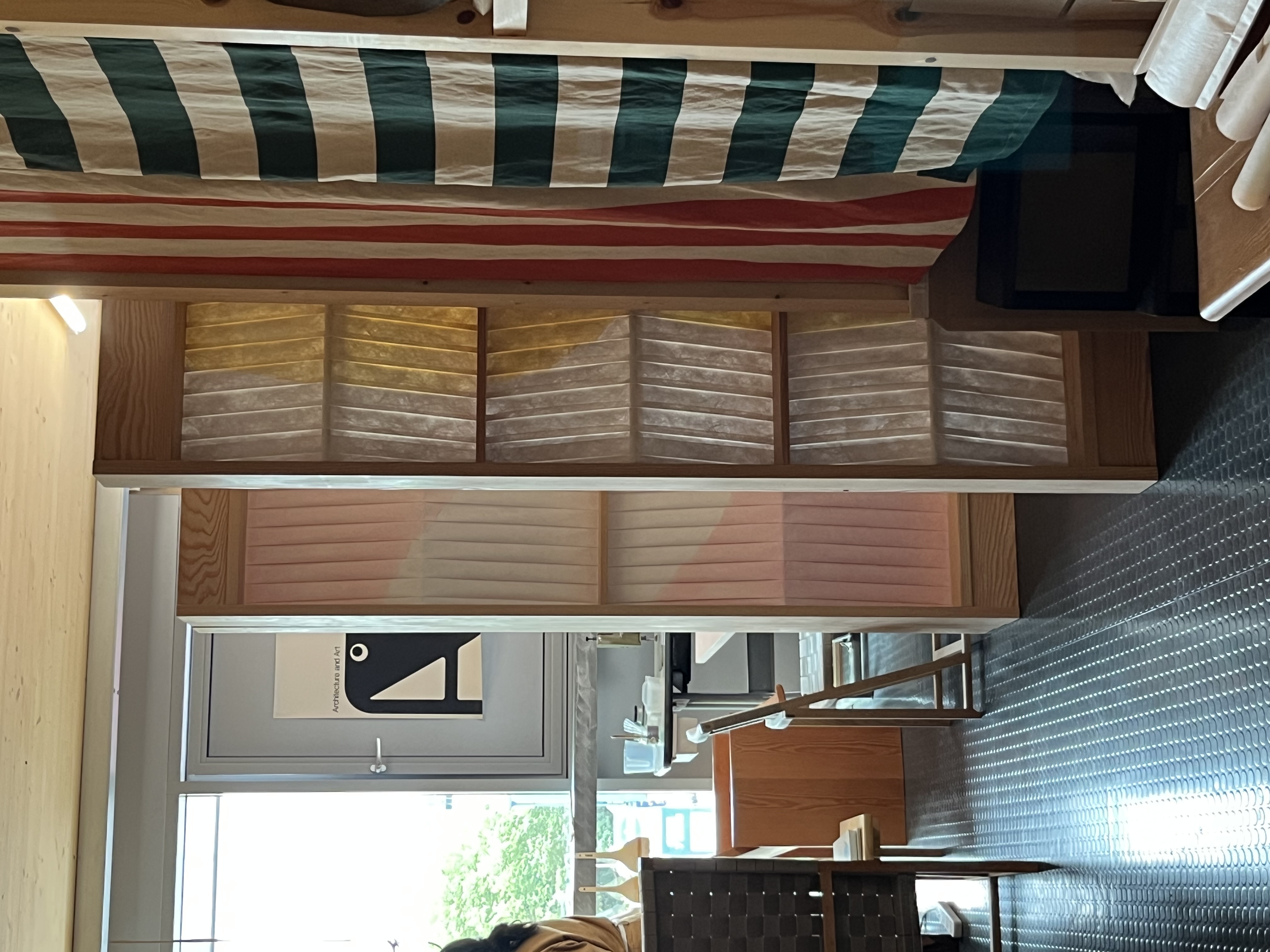 A series of colorful artwork panels upright in a studio